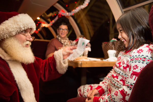 Little-Girl-with-Santa-at-Table-Reading-List